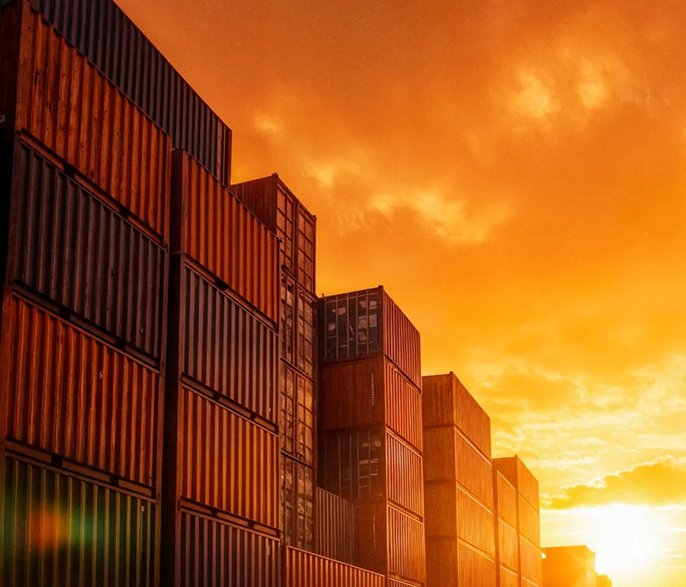 Stacked shipping containers at sunset